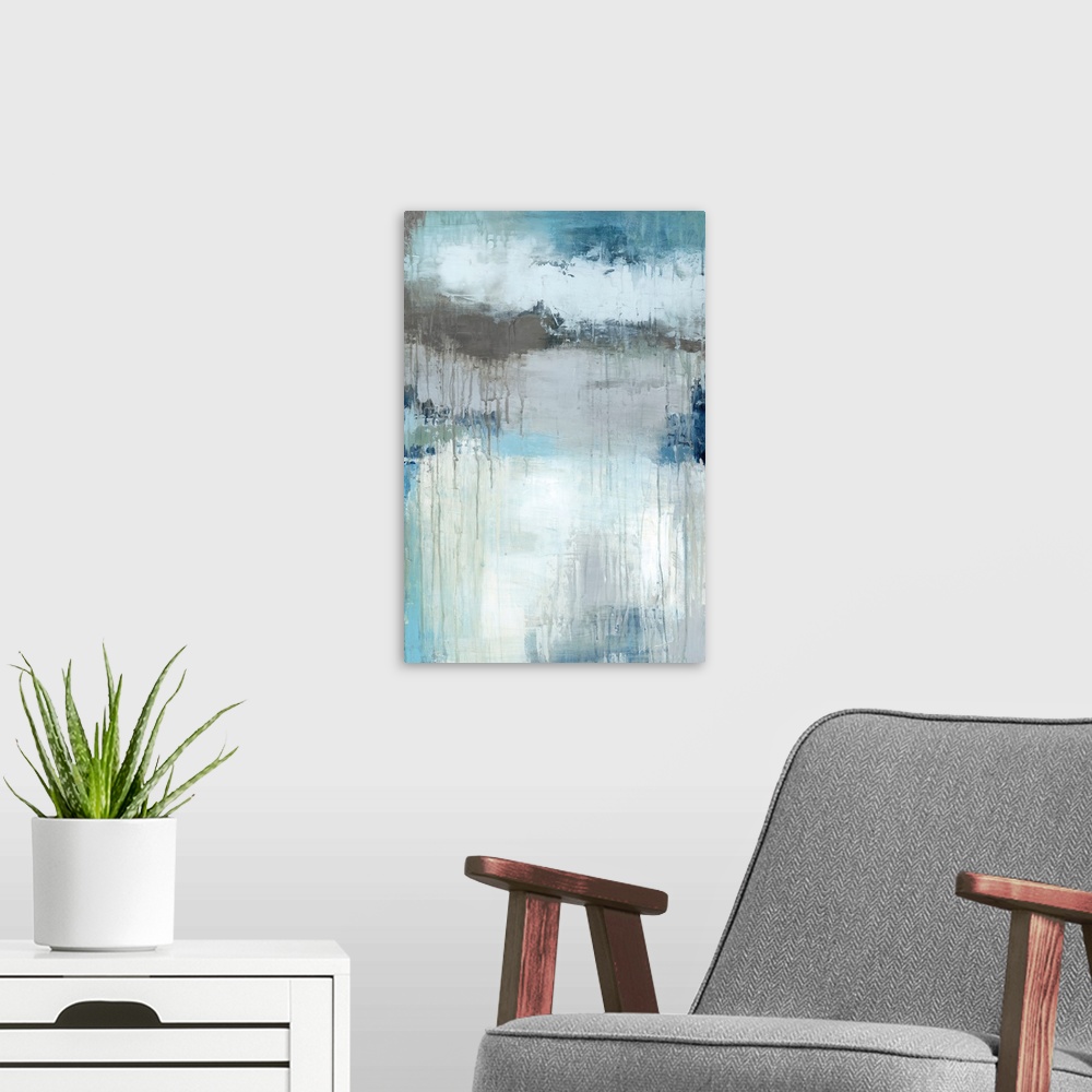 A modern room featuring Vertical abstract painting in textured colors of blue, brown, white and gray.