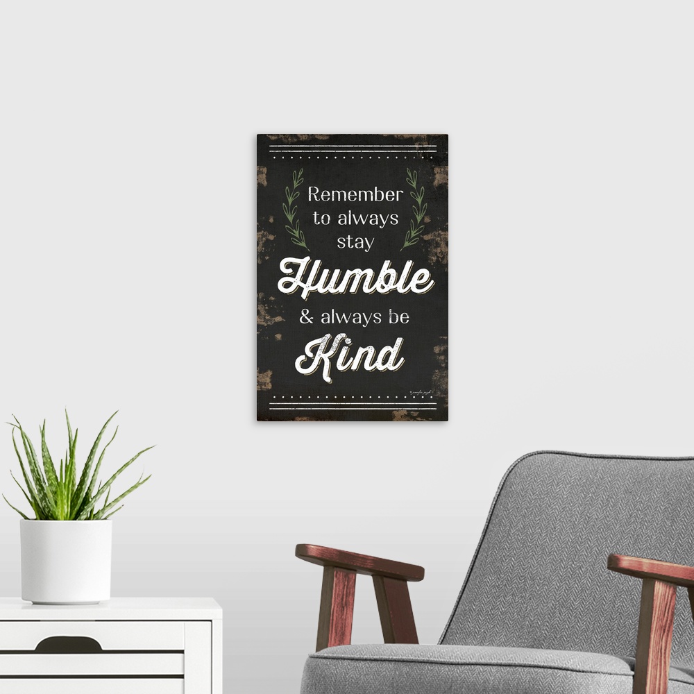 A modern room featuring "Remember to always stay Humble and always be Kind" on a weathered dark background.