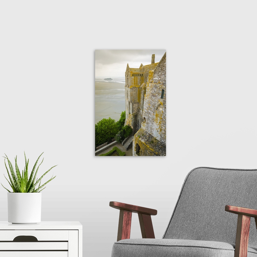 A modern room featuring Abbey walls and bay, Mont Saint-Michel monastery, Normandy, France.