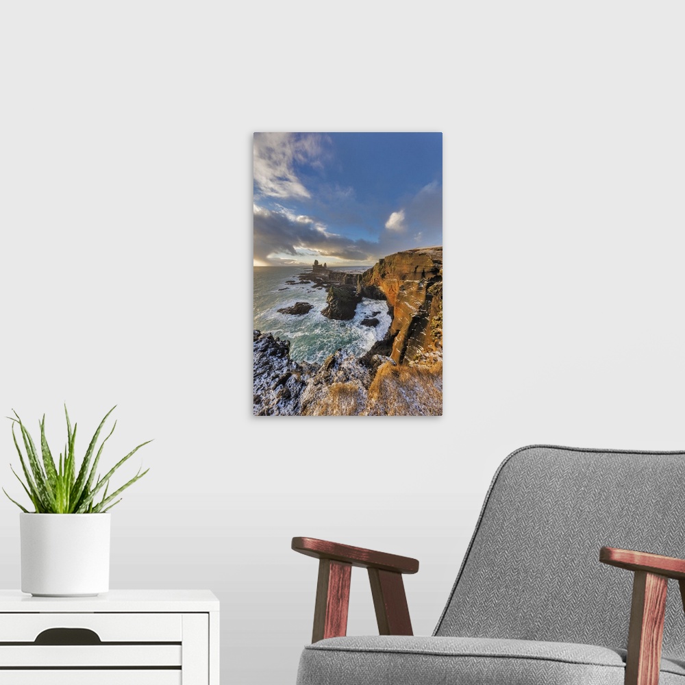 A modern room featuring Dramatic cliffs at Londrangar sea stacks in the North Atlantic ocean on the Snaefellsnes peninsul...