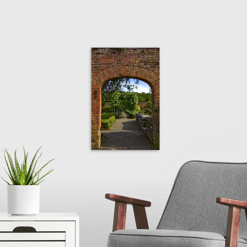A modern room featuring In Ireland,the Dromoland Castle Walled Garden path through a brick archway no people