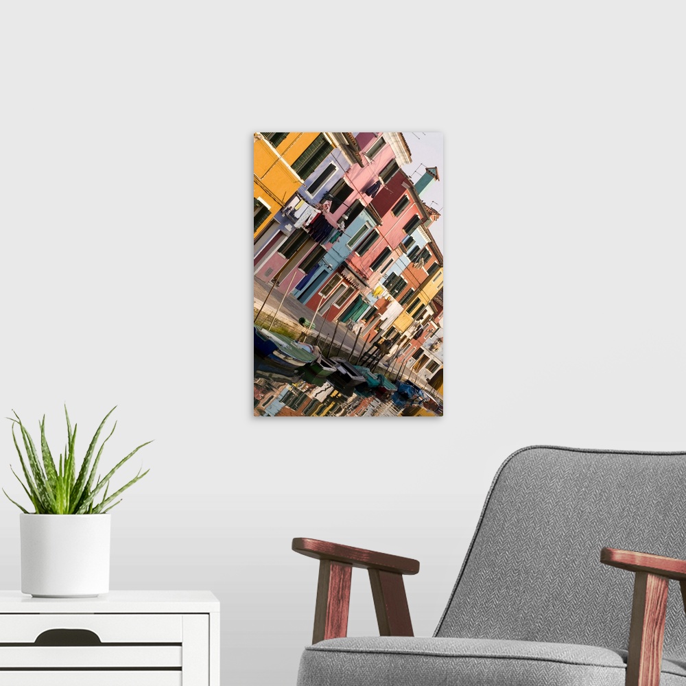 A modern room featuring Italy, Venice, Burano. A tilted view of colorful houses and their reflections on a canal.