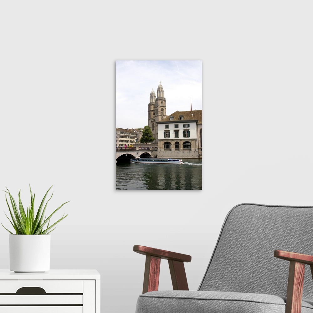 A modern room featuring Tour boat passes beneath Munster Bridge crossing the Limmat River in Zurich, Switzerland with tow...
