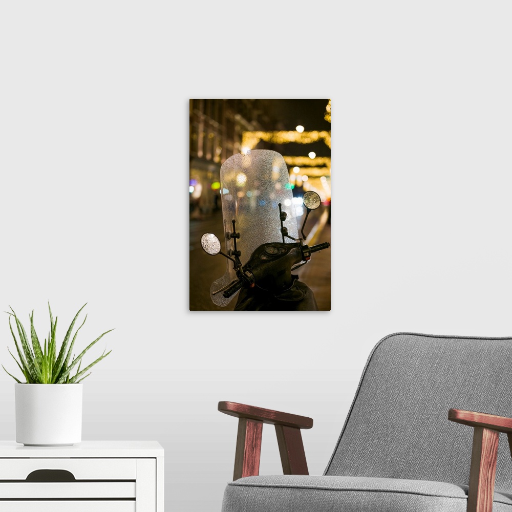 A modern room featuring Netherlands, Amsterdam, Utrechtstraat street, motorbike and Holiday decorations, evening.