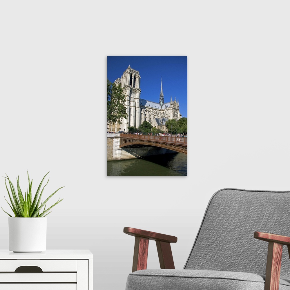 A modern room featuring Notre Dame cathedral along the river Seine in Paris, France.