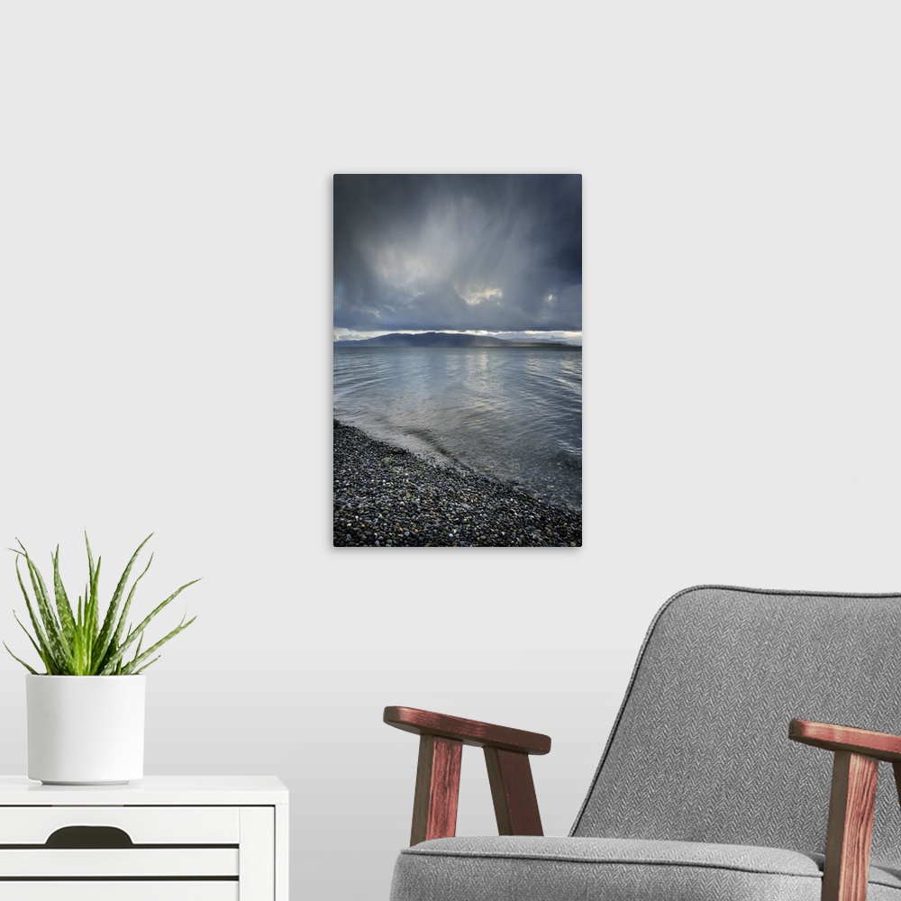 A modern room featuring Stormy winter clouds over Bellingham Bay, Washington State. Lummi Island in the distance.