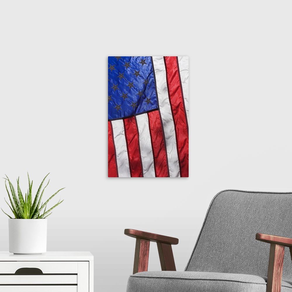 A modern room featuring Sunlight shines through an American Flag.
