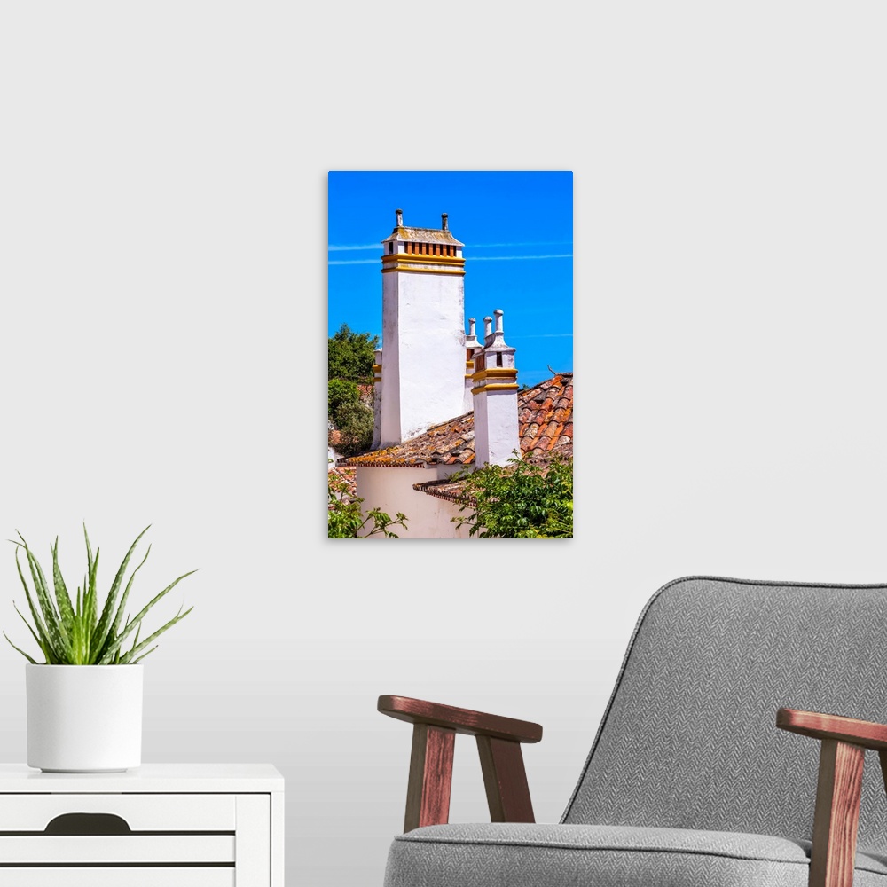 A modern room featuring Towers Chimnies Orange Roofs Medieval Town Obidos Portugal. Castle and walls built in 11th centur...
