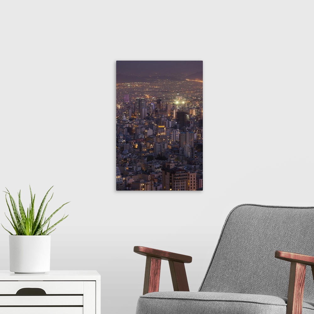 A modern room featuring Iran, Tehran, elevated city skyline with view tfrom the Roof of Iran Park towards the Milad Tower...