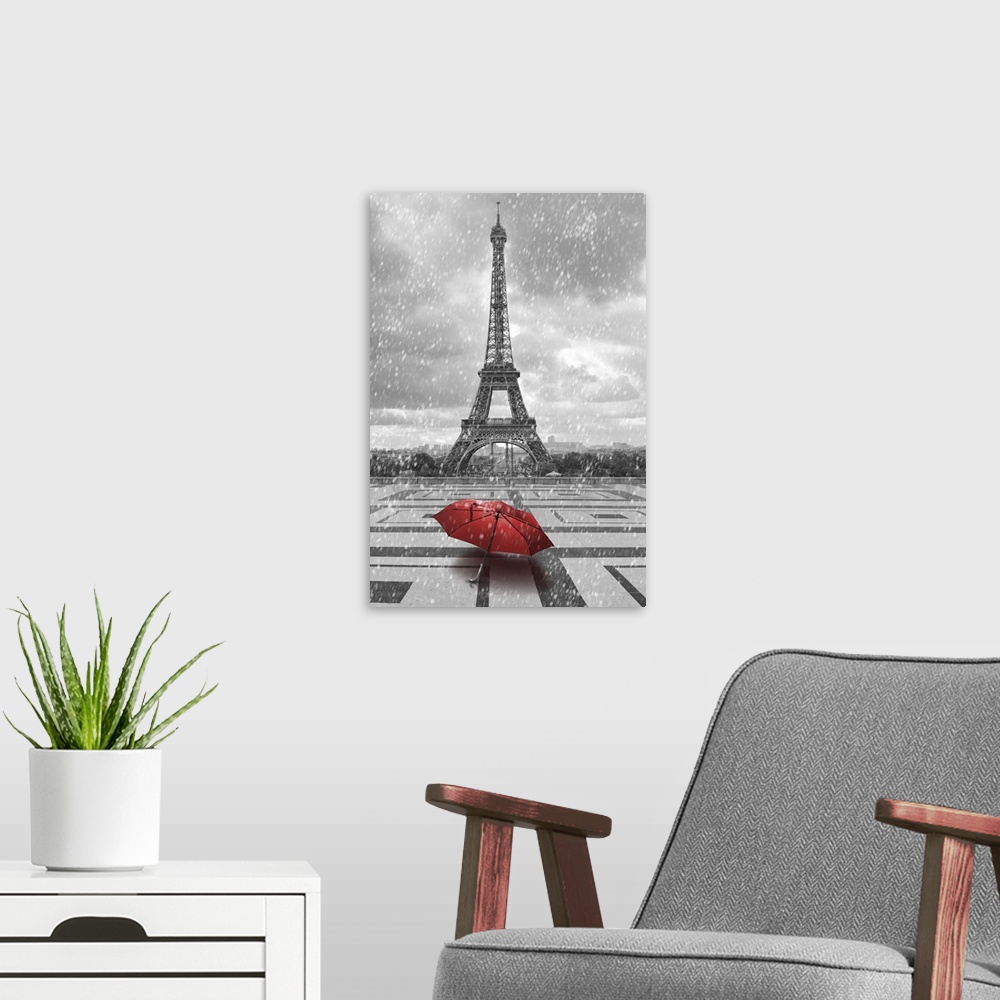 A modern room featuring Eiffel tower in the rain with red umbrella. Black and white photo with red element.