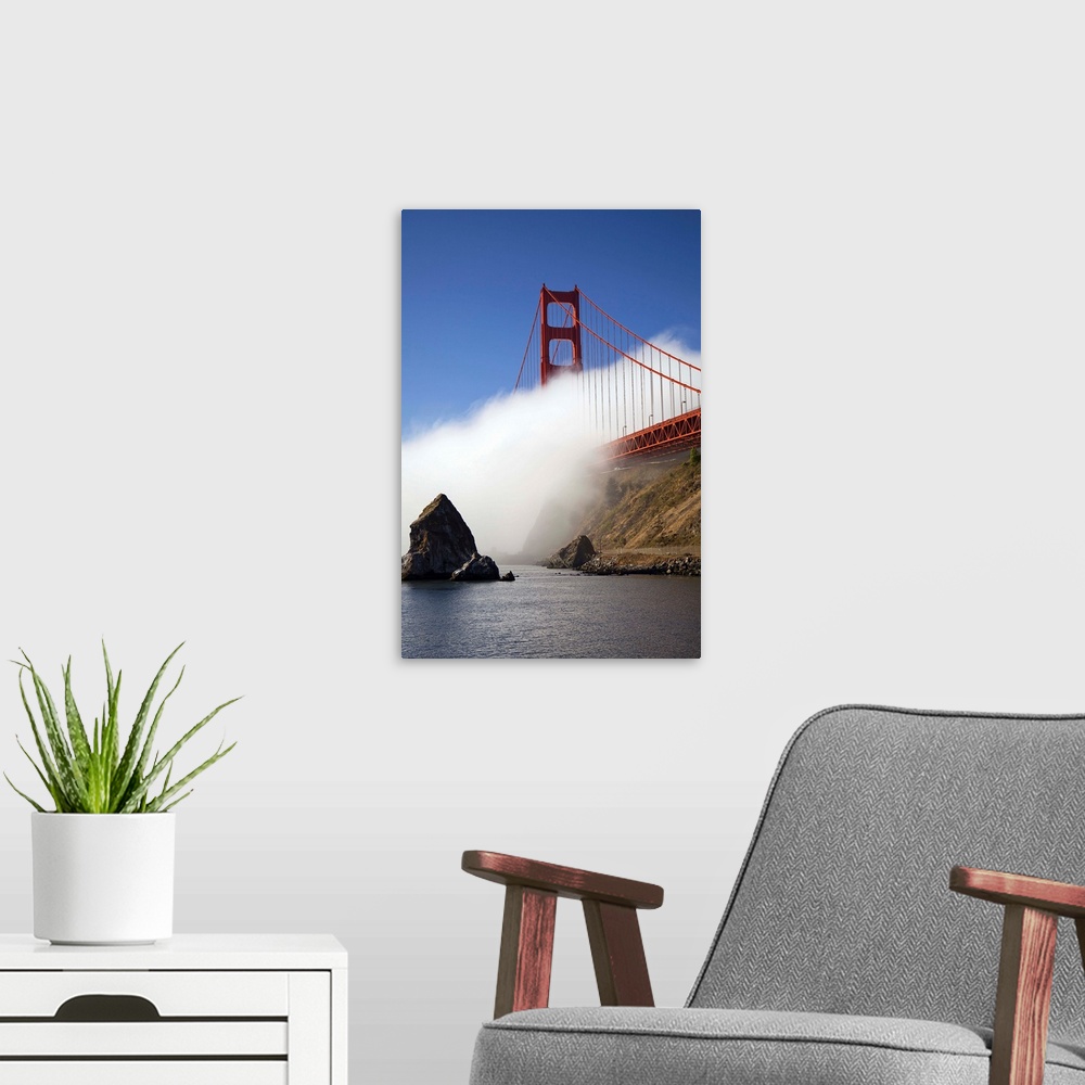 A modern room featuring California, San Francisco, fog rolling under Golden gate Bridge