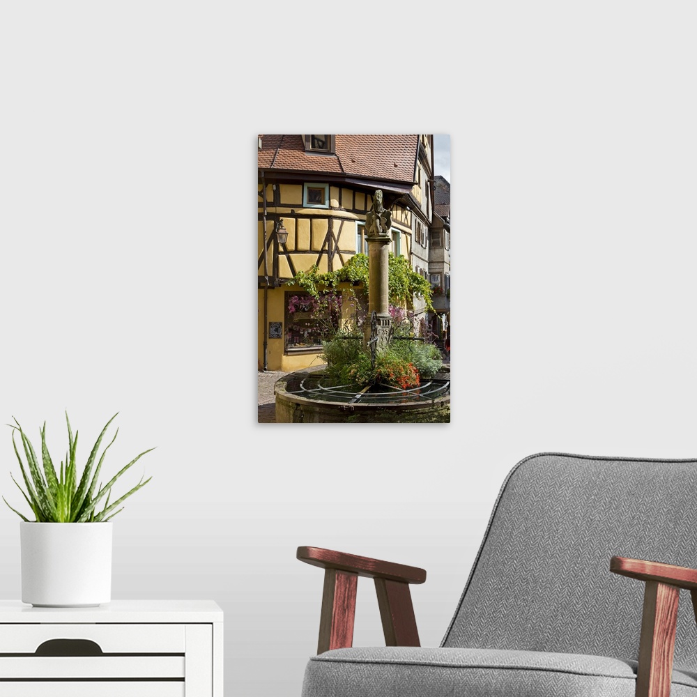 A modern room featuring France, Alsace, Riquewihr, Haut-Rhin, Picturesque fountain in the village centre