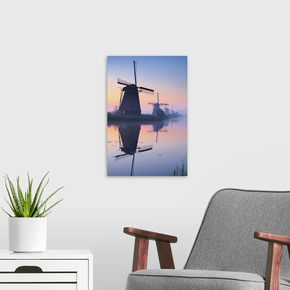 A modern room featuring Netherlands, South Holland, Kinderdijk, Windmills at sunrise.