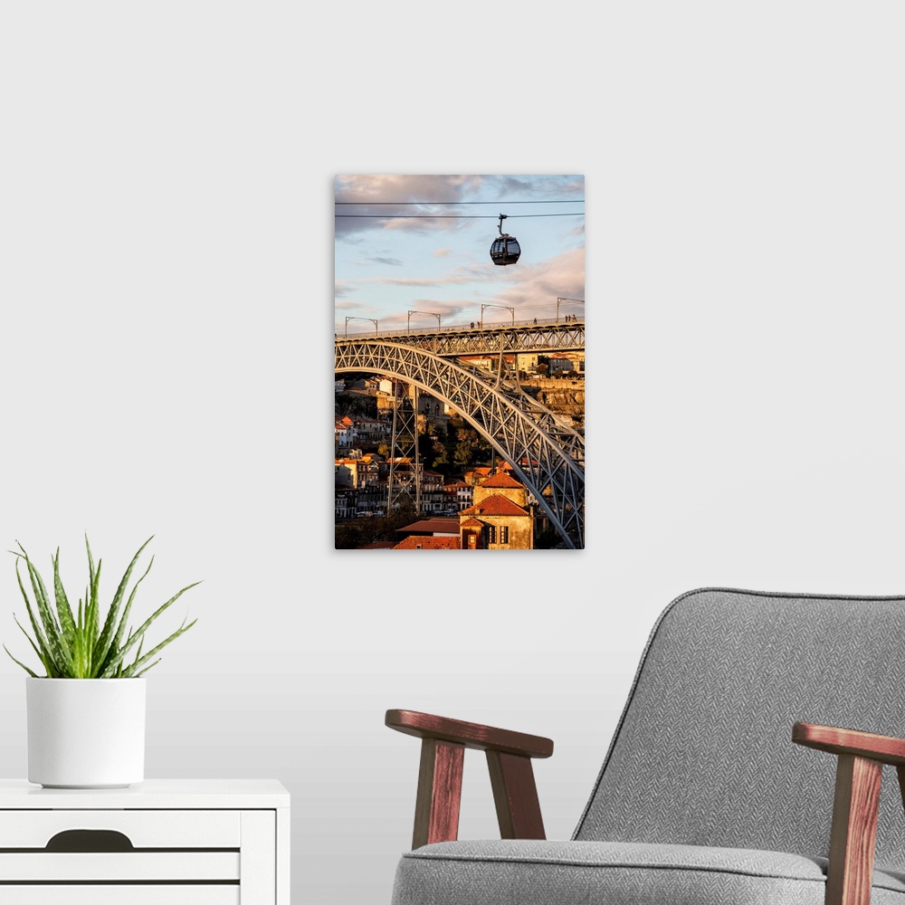A modern room featuring Portugal, Porto, Cable car over the bridge at sunset.