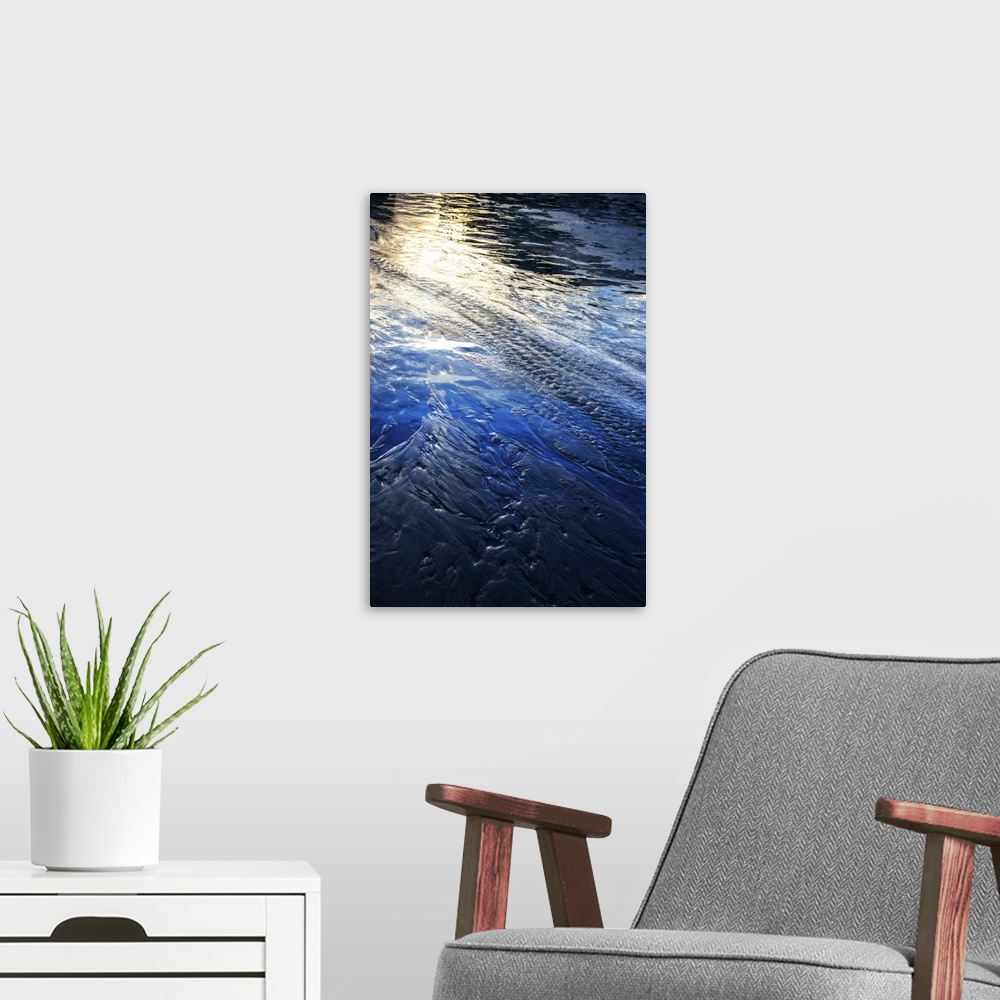 A modern room featuring Photograph of water trails with the sunlight reflecting off the blue water.