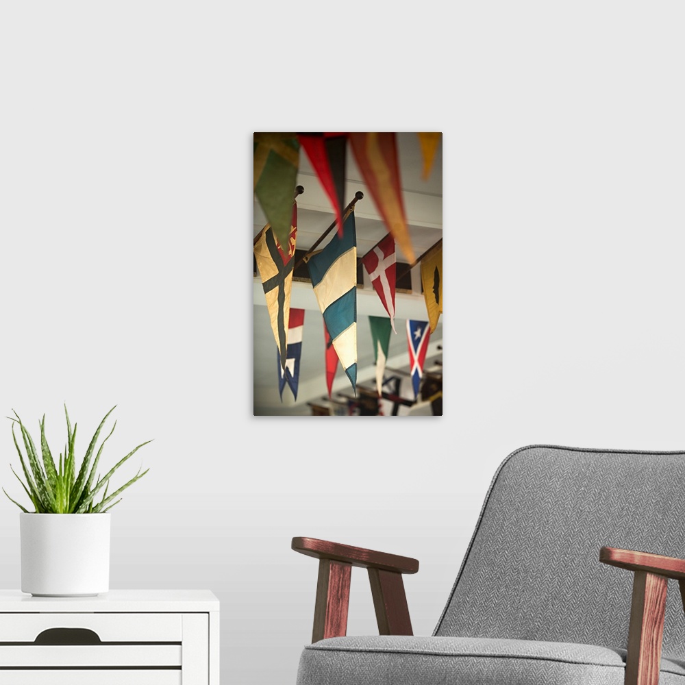 A modern room featuring Close-up photograph of flags hanging on the ceiling of a yacht club.