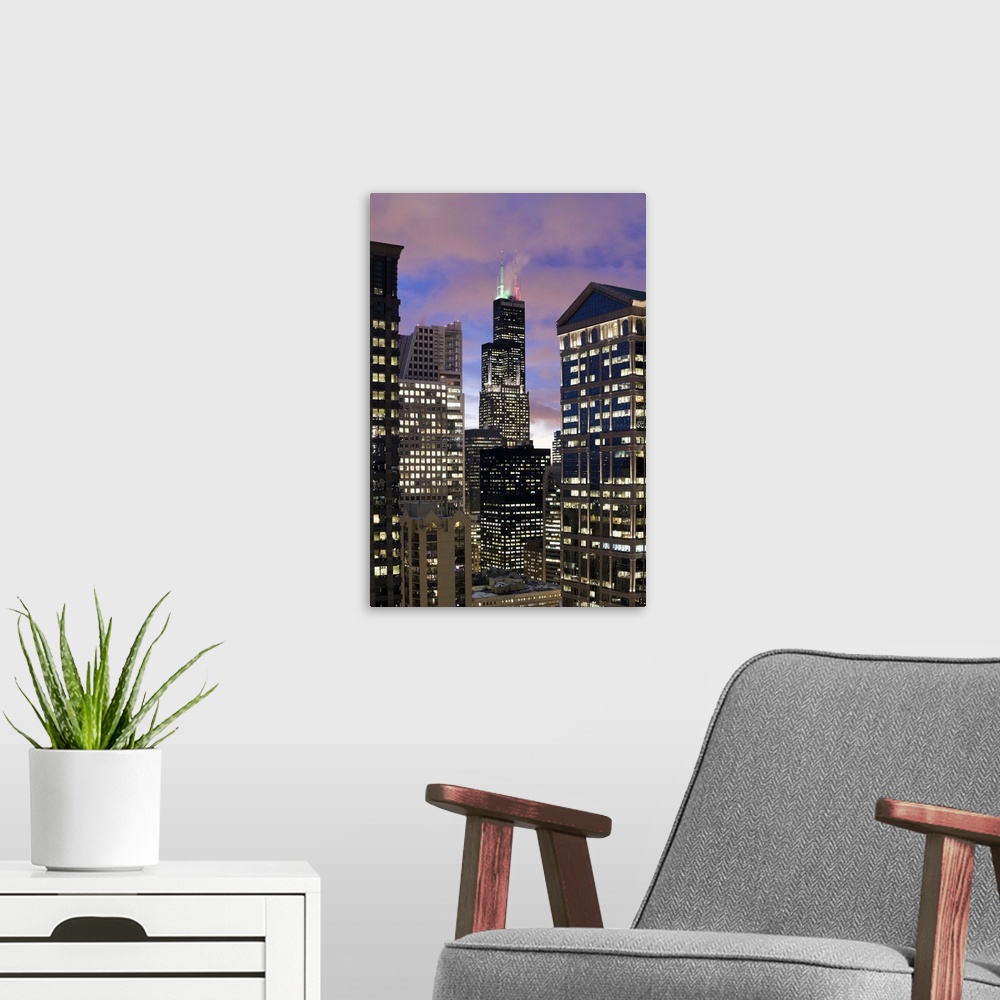 A modern room featuring Aerial view of buildings in the Chicago Loop, including Sears Tower and City Hall at dusk.
