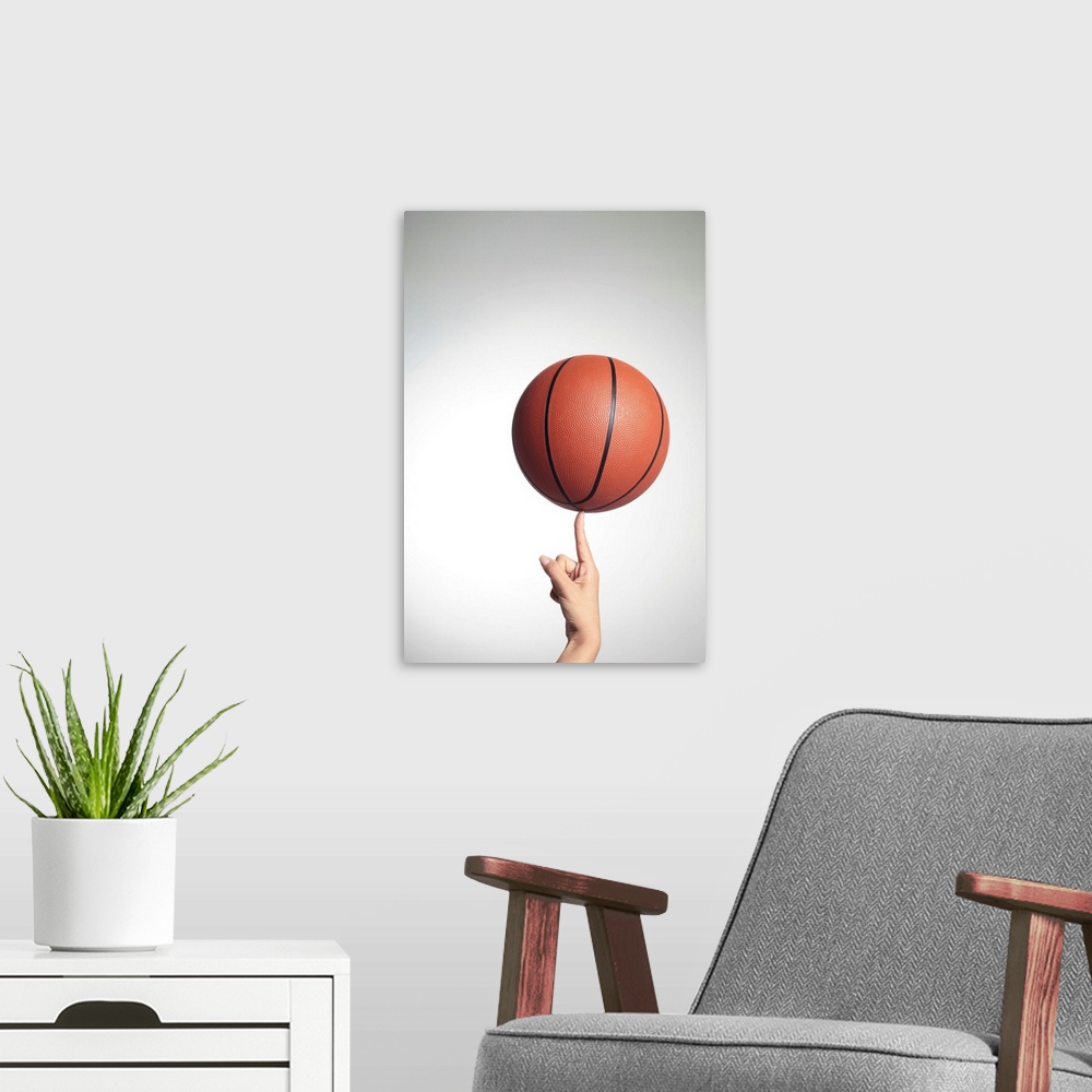 Basketball on index finger, hands close-up Solid-Faced Canvas Print