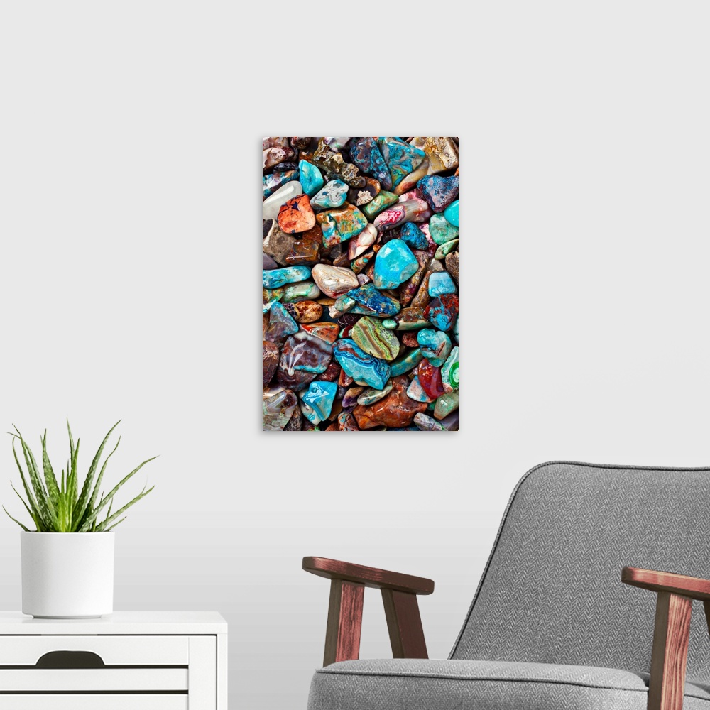 A modern room featuring Large close-up photograph focuses on an abundance of vibrantly tinted smooth rocks as they sit ne...