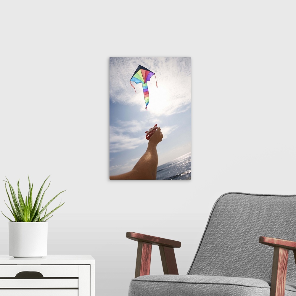 A modern room featuring Hand holding string of flying kite
