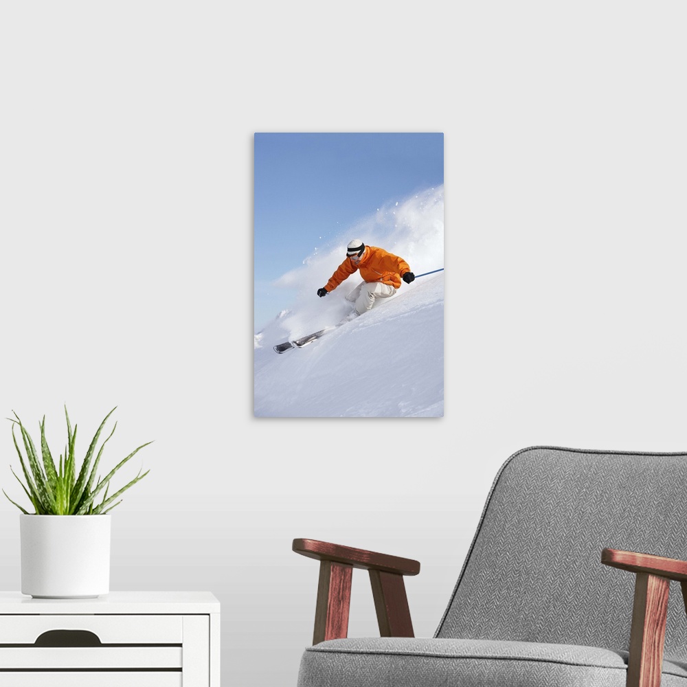 A modern room featuring Man skiing down snow mountain slope sending up spray
