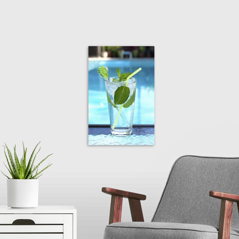 A modern room featuring Mojito cocktail by a swimming pool