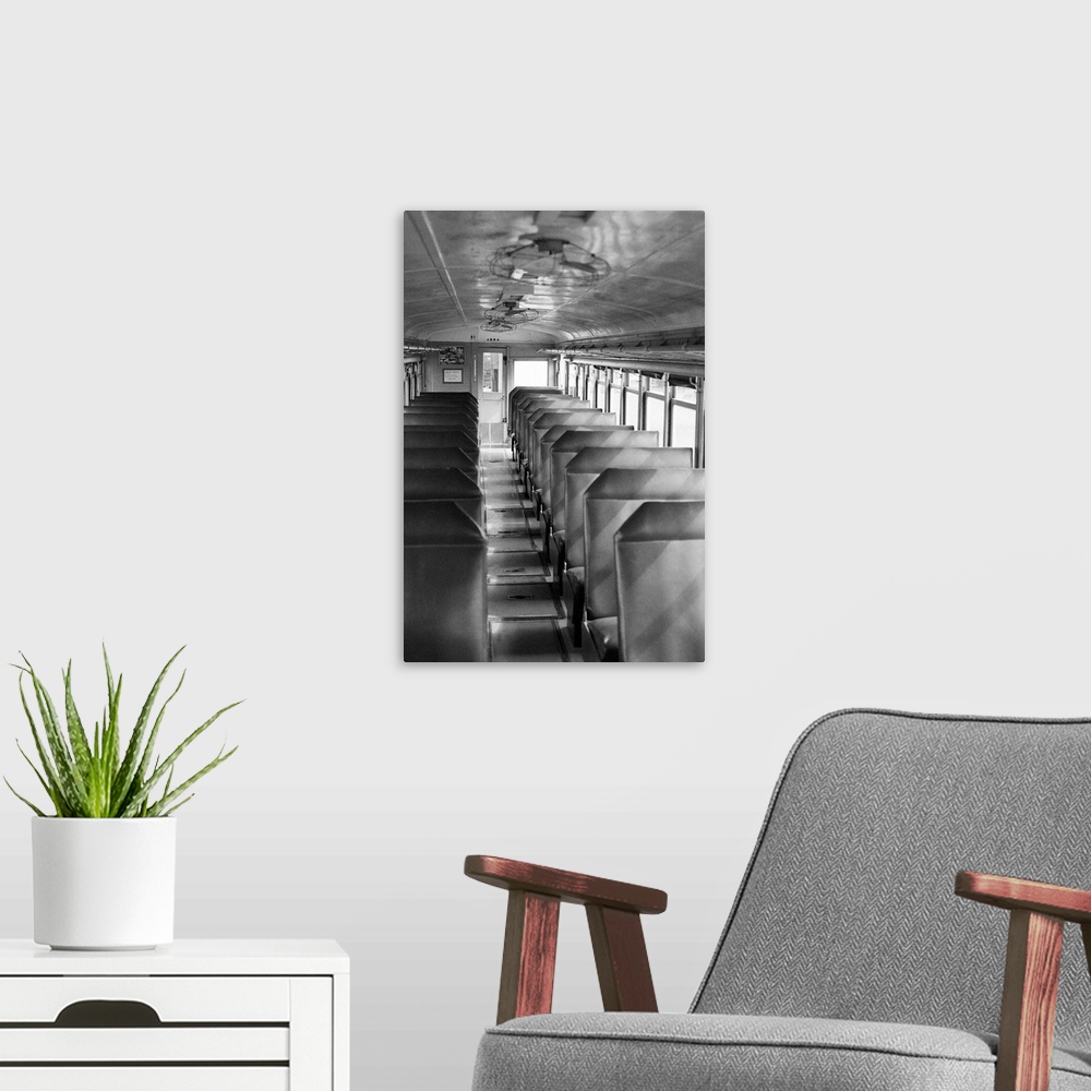 A modern room featuring Black and white image of old passenger car of train.