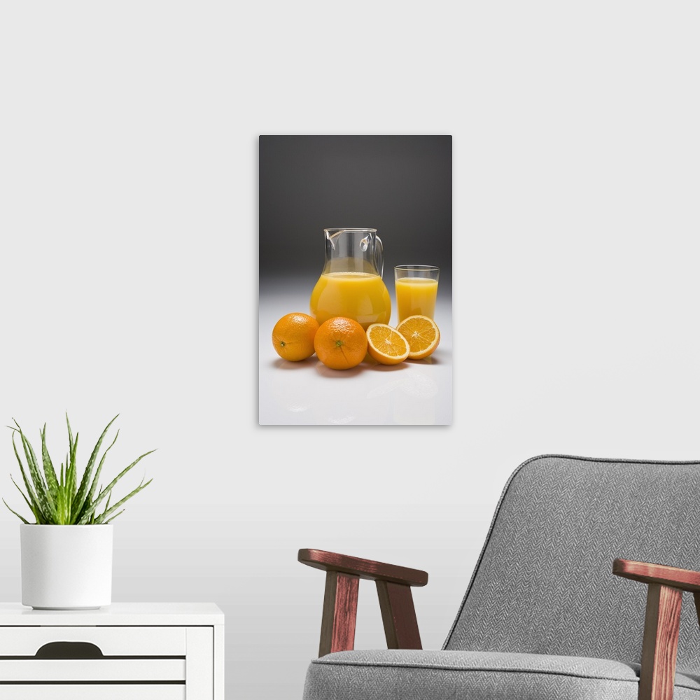A modern room featuring Oranges with a Pitcher and a Glass of Orange Juice