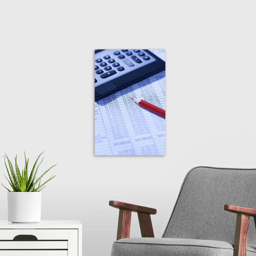 A modern room featuring Pocket calculator and red pencil on spreadsheet