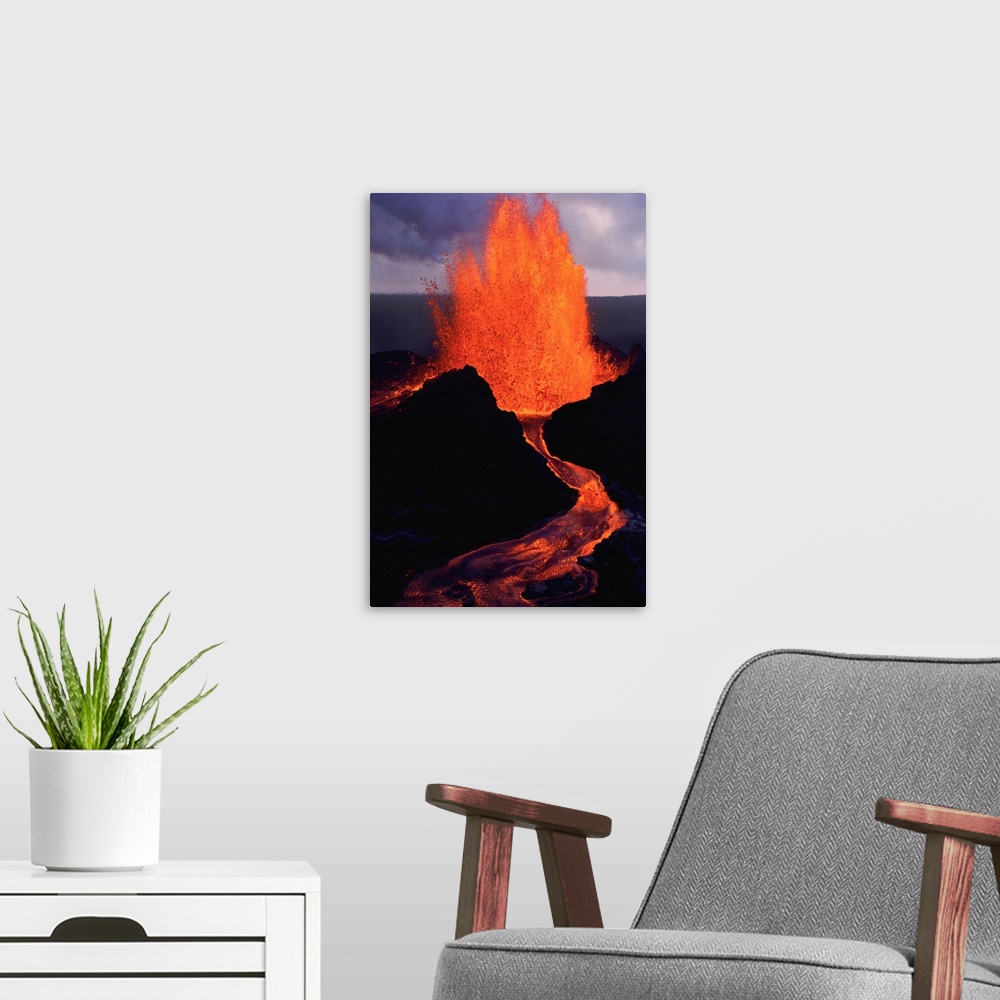 A modern room featuring Puu Oo, the easternmost of Kilauea's craters, spews molten lava.