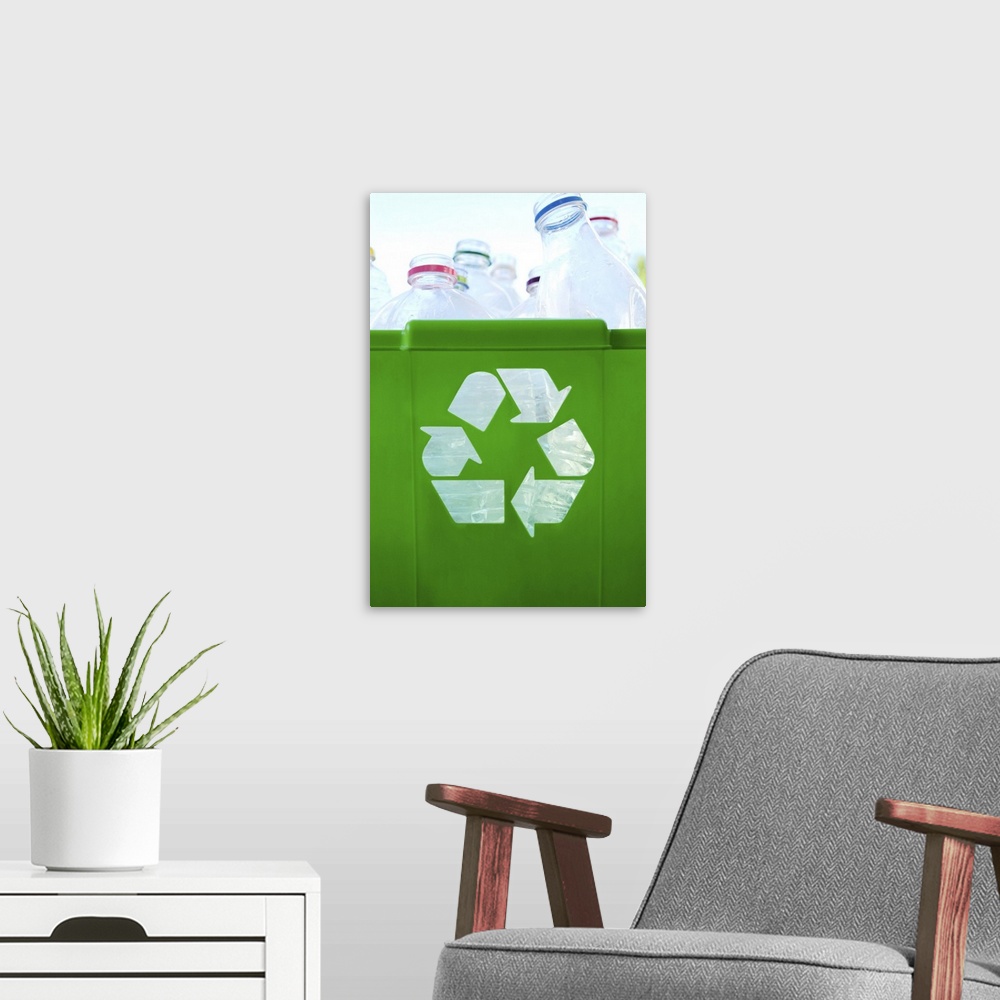 A modern room featuring Recycling logo cut out of green plastic container