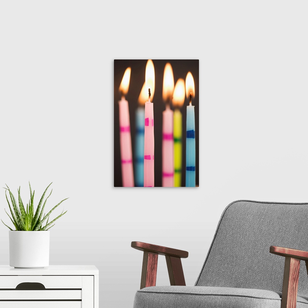 A modern room featuring Six Lit Birthday Candles