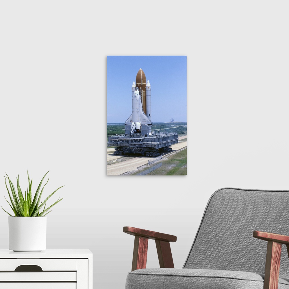 A modern room featuring Kennedy Space Center, Florida: The space shuttle Challenger is slowly rolled out to the launch pa...