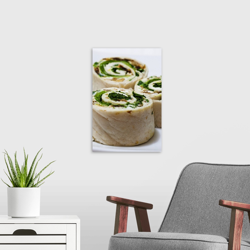 A modern room featuring Tortilla rolls filled with goat's cheese and salad, close-up