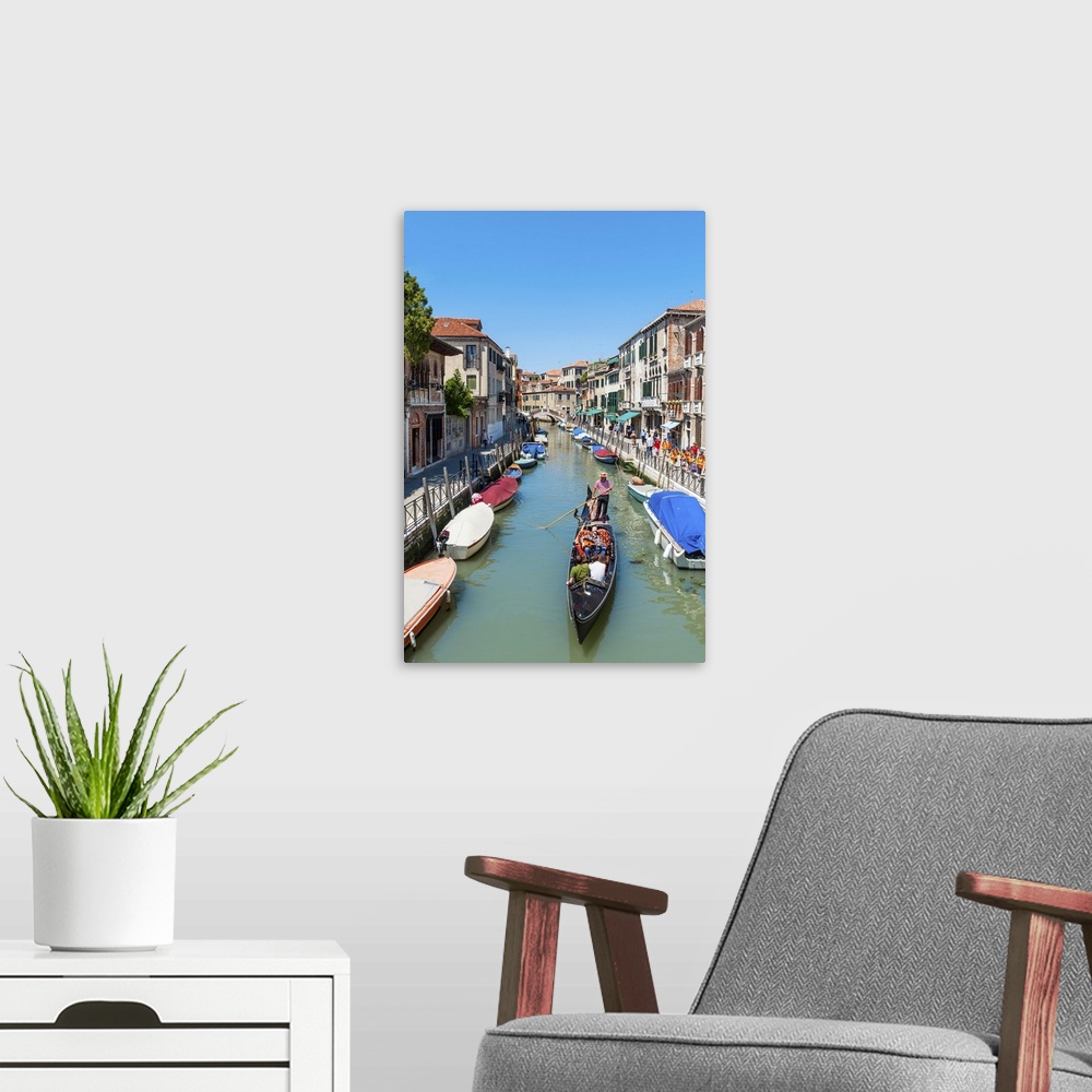 A modern room featuring View of gondola on the canal in Venice, Italy.