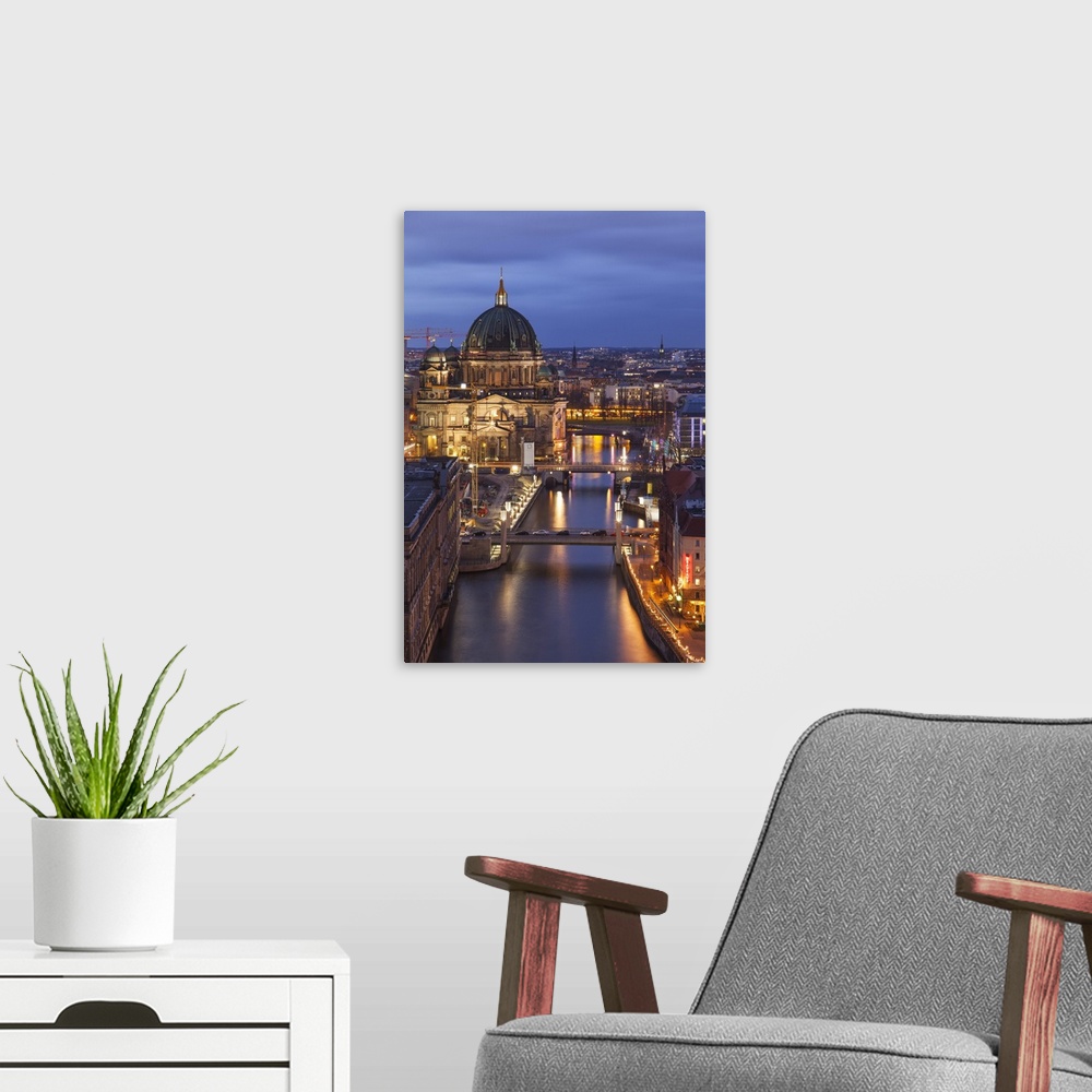 A modern room featuring Berlin Cathedral, Berliner Dom, seen fom the Fischerinsel at dusk, the river Spree in the foregro...