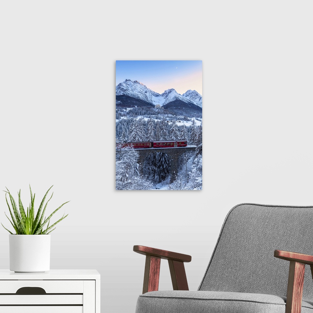 A modern room featuring Bernina Express transit on the viaduct in winter. Lower Engadine, Canton of Grisons, Switzerland,...