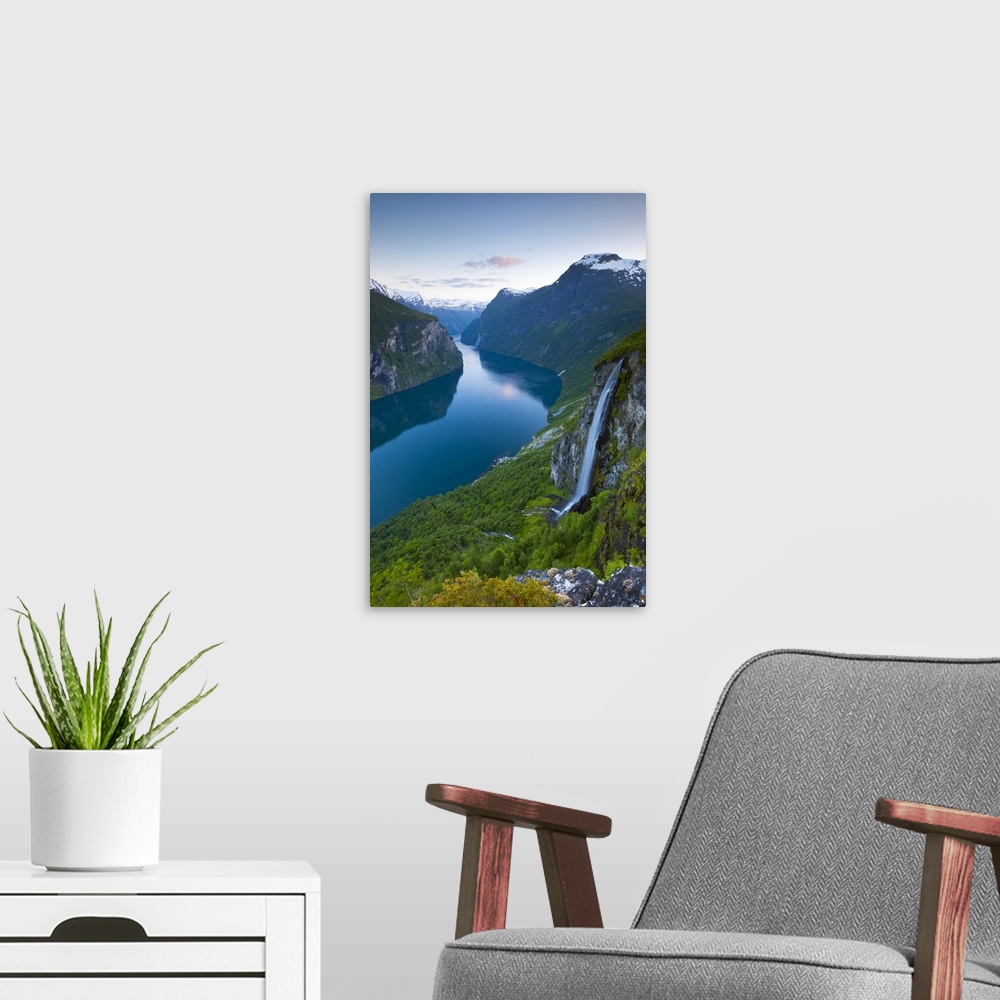 A modern room featuring The Majestic Geiranger Fjord illuminated at dusk, Geiranger, More og Romsdal, Norway