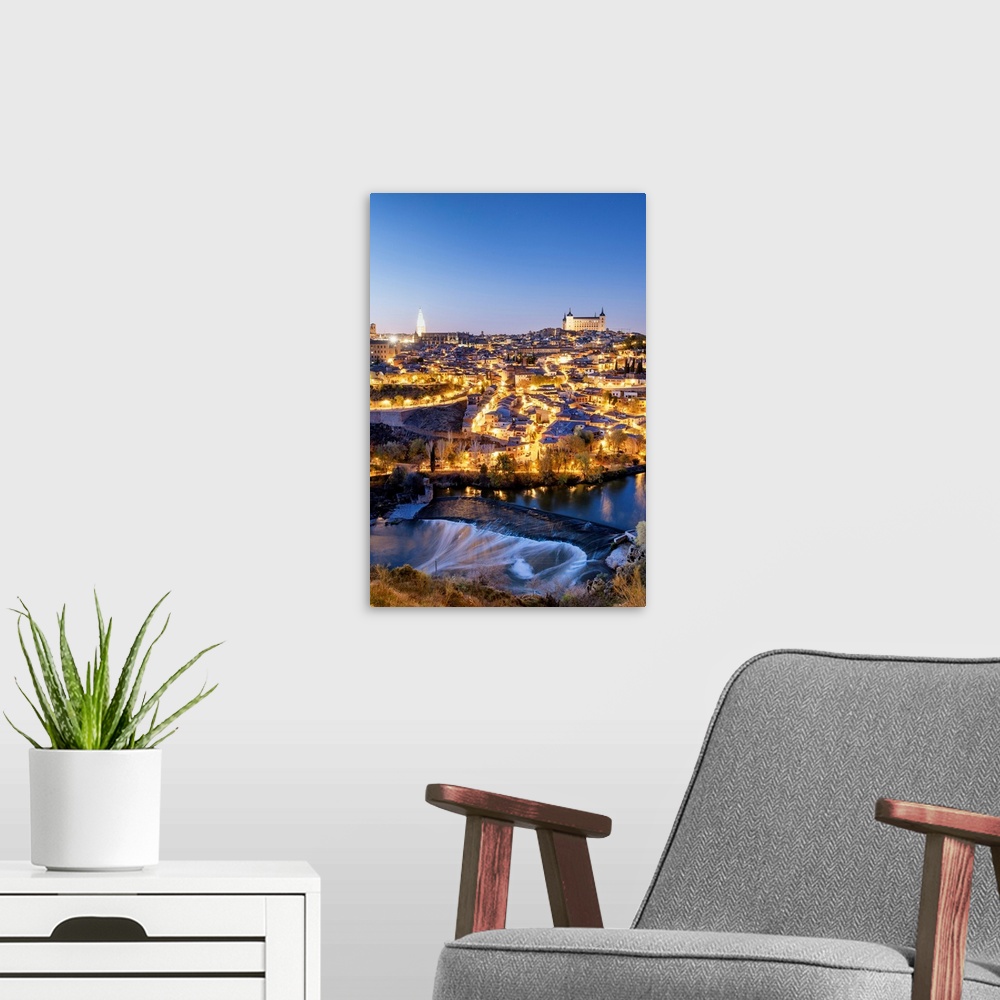 A modern room featuring Toledo and the Tagus river at twilight, a UNESCO World Heritage Site. Castilla la Mancha, Spain.