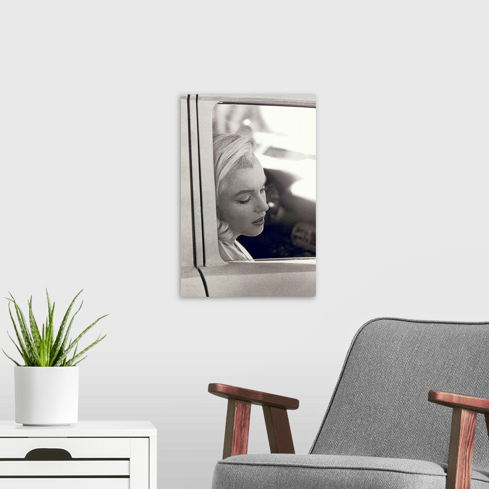 A modern room featuring Vintage photo of the popular celebrity resting her head against the window of a car door, her eye...