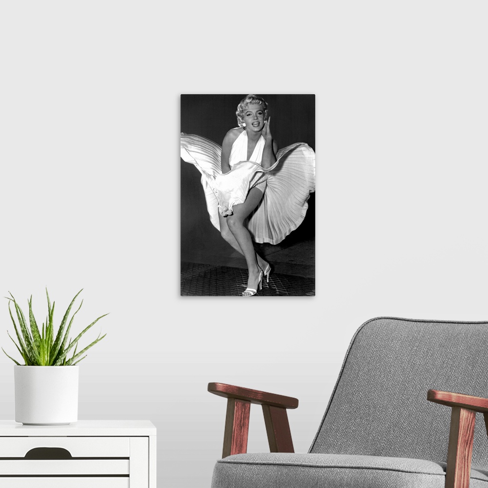 A modern room featuring A vertical photograph of the actress in her white dress and high heels standing over a subway gra...