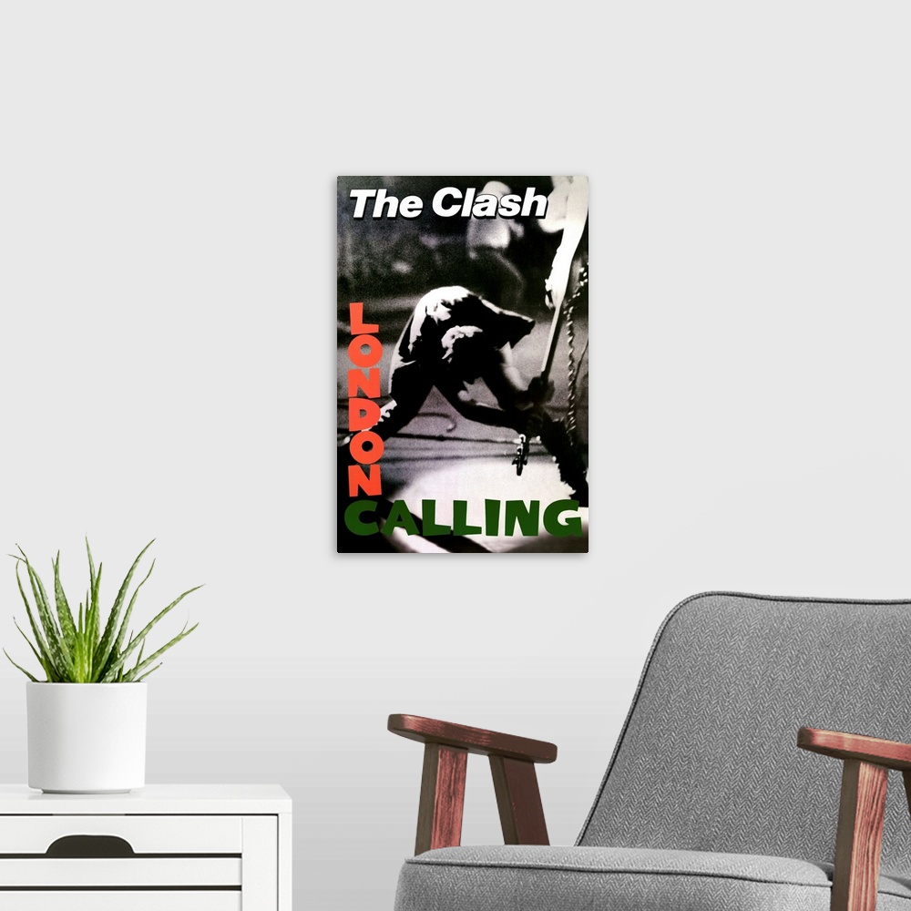 A modern room featuring Vertical, oversized black and white photograph of a band member of The Clash swinging a guitar to...