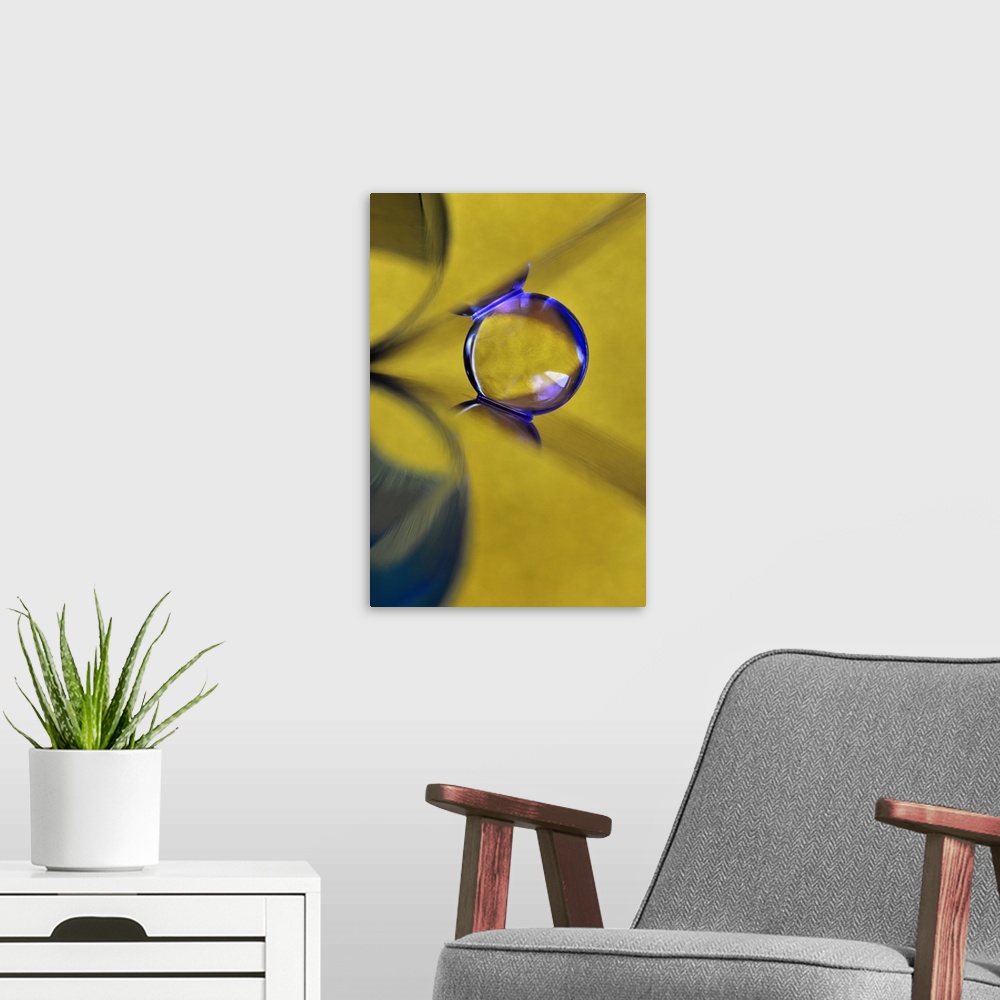 A modern room featuring Macro abstract photograph of a water droplet reflecting on a yellow surface.