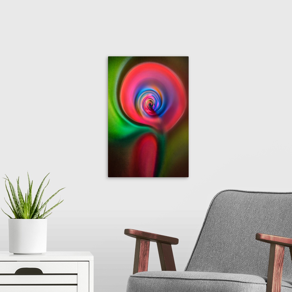 A modern room featuring Abstract photograph in green and red swirling shapes, resembling a candle.