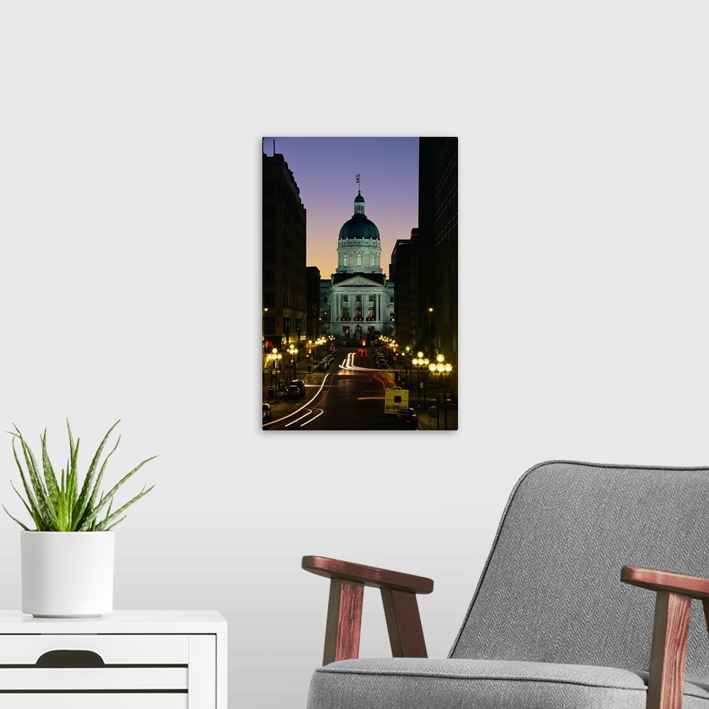 A modern room featuring Tall canvas photo art of the Capitol Building in Indiana lit up at dusk seen from the front with ...