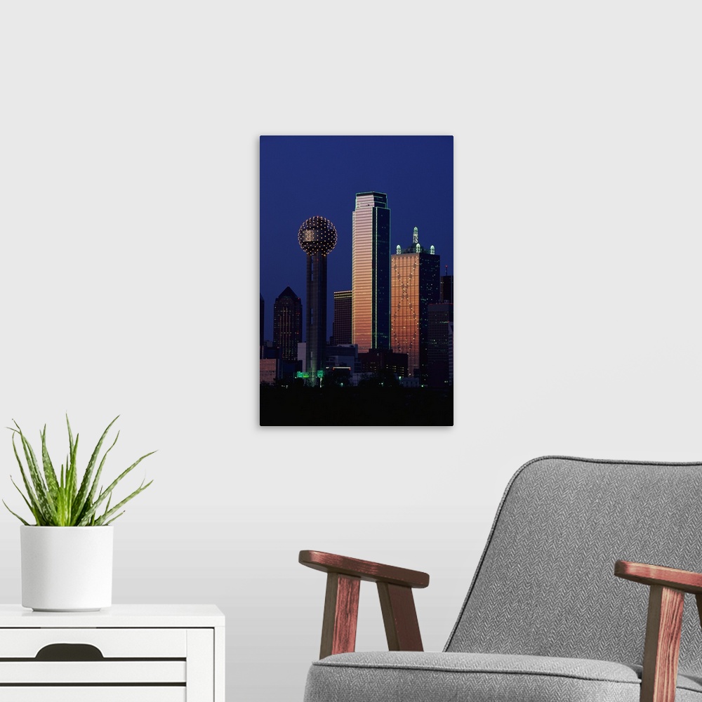 A modern room featuring This large vertical piece is a photograph that has been taken of the Dallas skyline with the buil...