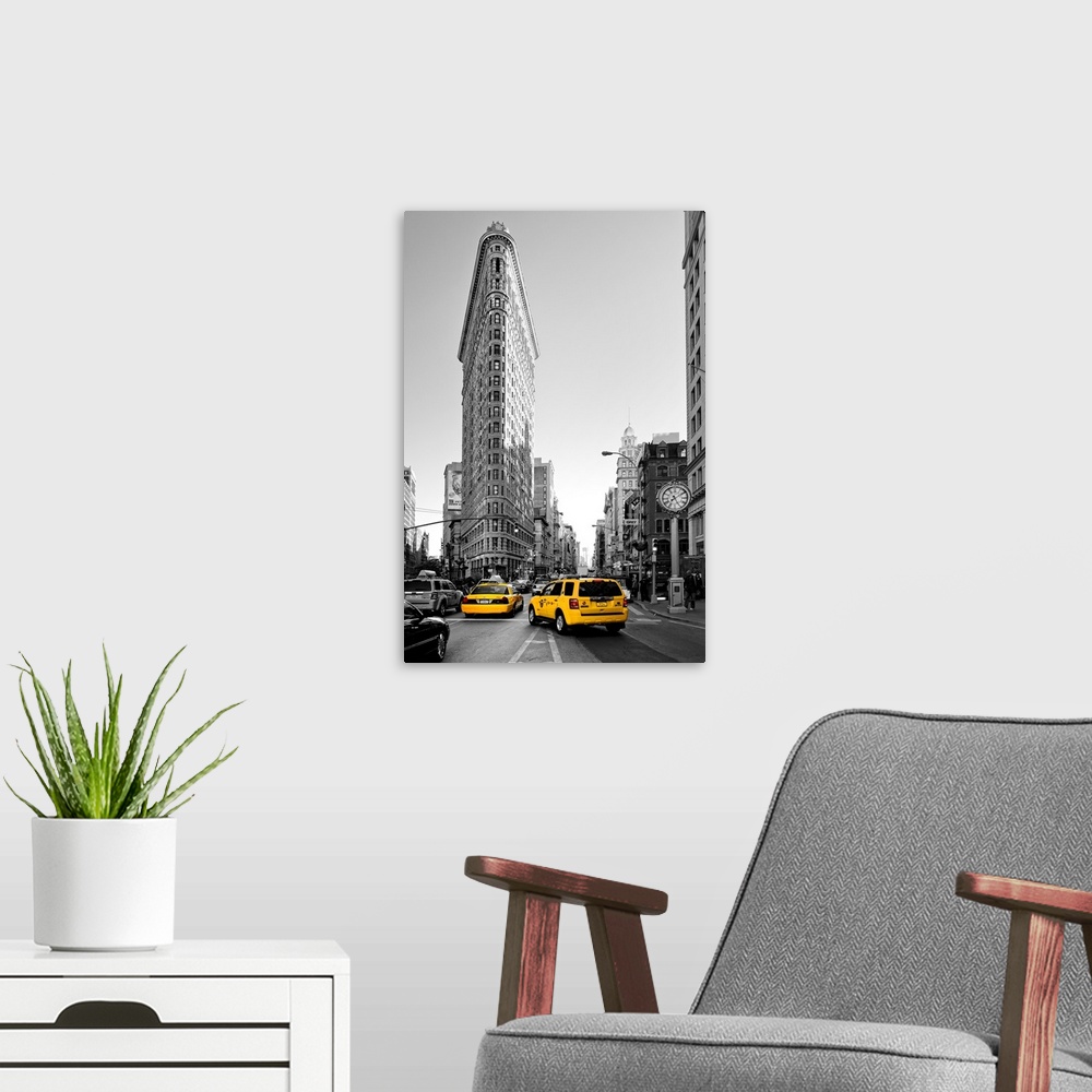 A modern room featuring Fine art photo of the Flatiron Building, seen from the street, with yellow taxi cabs.
