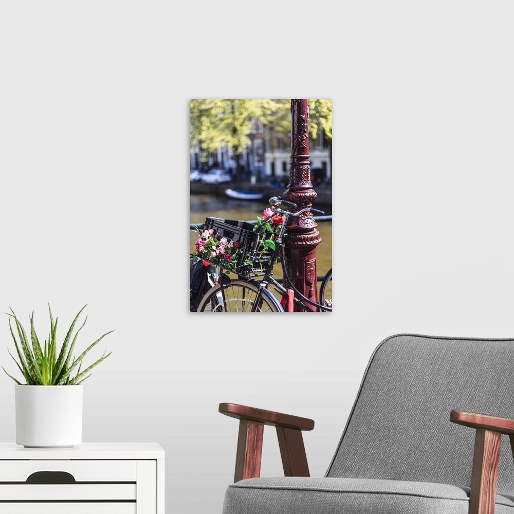 A modern room featuring A bicycle decorated with flowers by a canal, Amsterdam, Netherlands