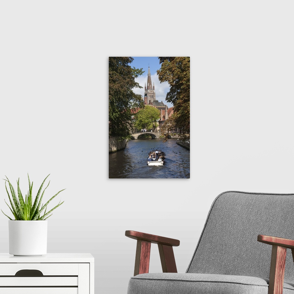 A modern room featuring Bridge to Begijnhof, and spire of Church of Our Lady, tourist launch, Bruges, UNESCO World Herita...