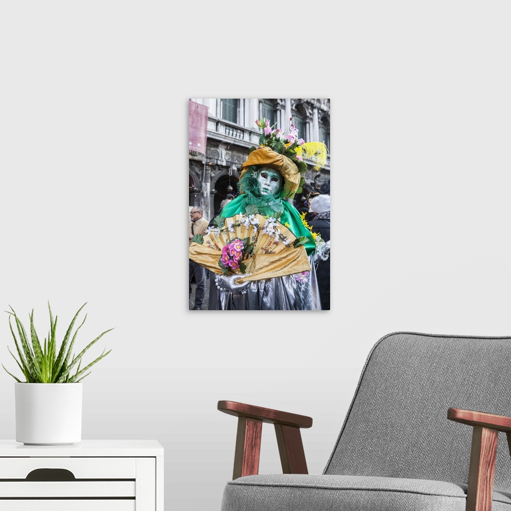 A modern room featuring Colourful mask and costume of the Carnival of Venice, famous festival worldwide, Venice, Veneto, ...